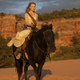 Dolores rides, not exactly into the sunset.